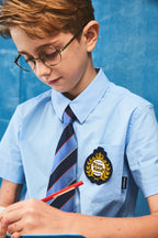 Boy wearing a blue short-sleeve summer casual button-up shirt with front pocket by Everanne, perfect for warm weather.
