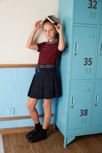 Everanne girls' navy mini skirt with bow tie belt, lightweight twill fabric, suitable for school or casual wear.