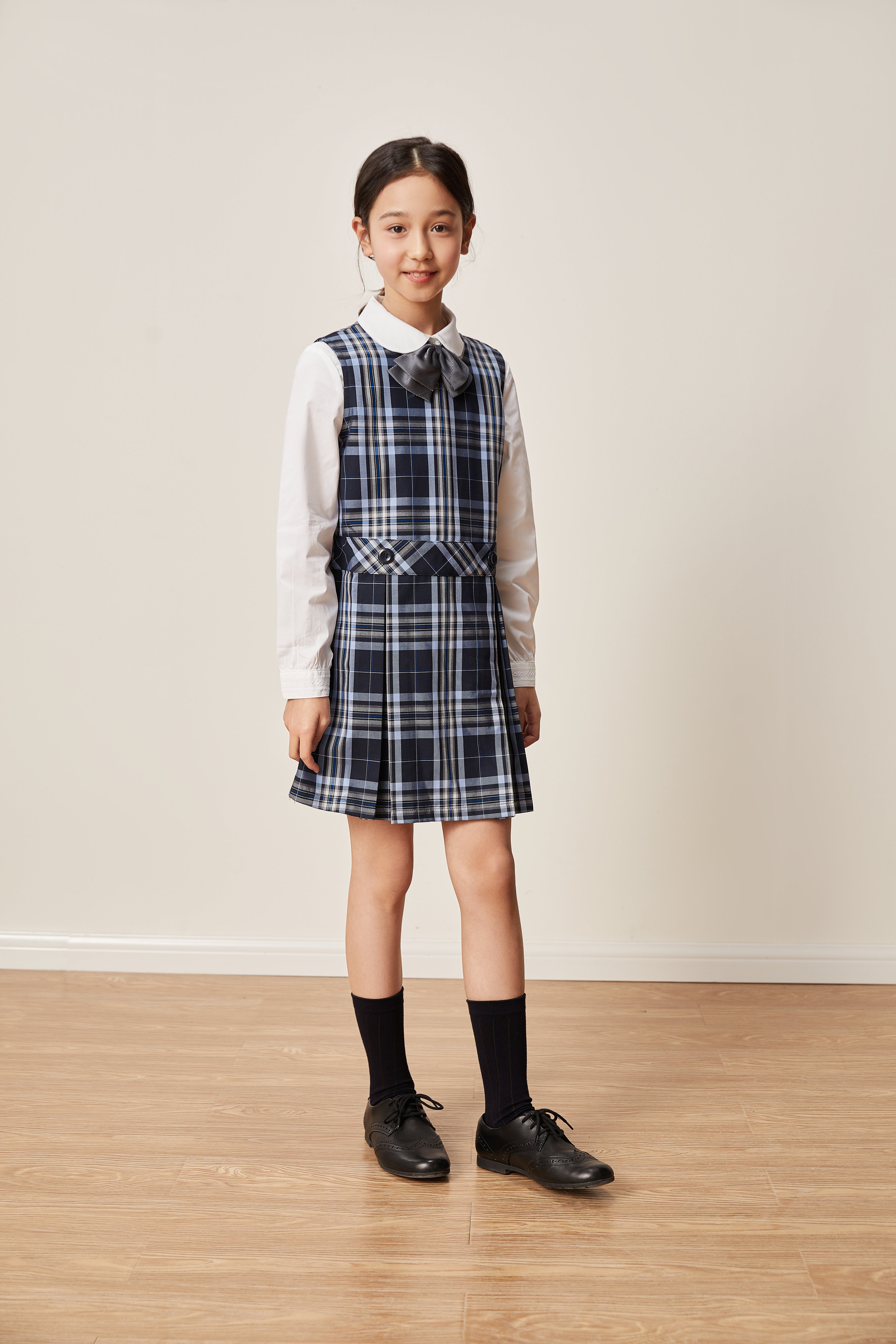 Everanne girls' navy plaid school uniform jumper dress with pleated skirt, featuring a classic and stylish design.