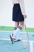 Everanne girls' preppy navy skirt with adjustable waist and built-in shorts, styled for a casual or school look