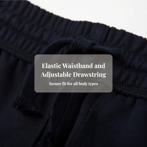 Everanne slim tapered blue jogger sweatpants with elastic waist and cuffed hems, made of cotton and nylon fabric.