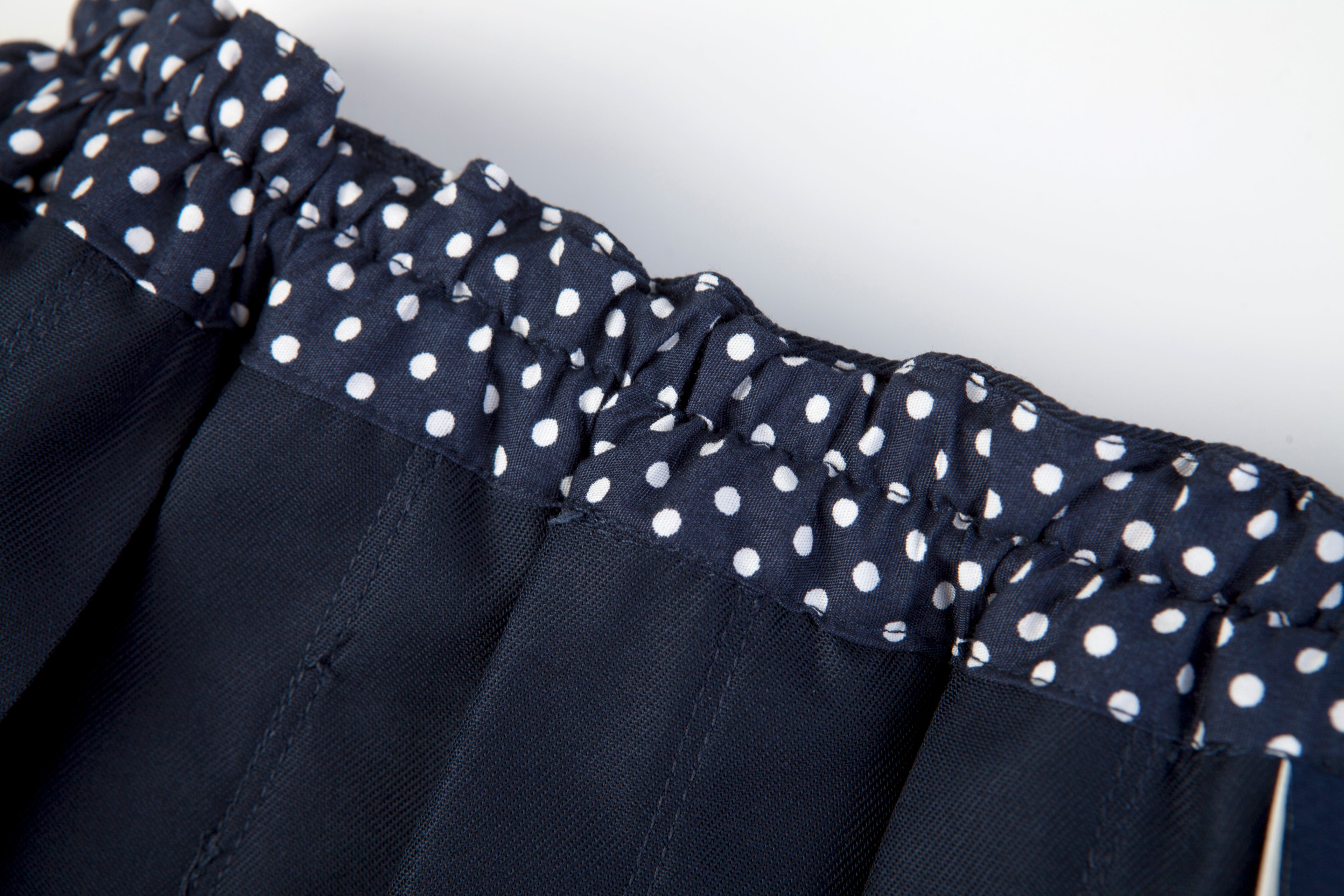 Everanne girls' navy mini skirt with bow tie belt, lightweight twill fabric, perfect for school or casual wear.