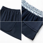 Everanne girls' navy preppy skirt with adjustable waist and built-in shorts, featuring a classic, stylish design.