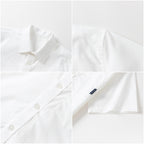Boy wearing a white Everanne short-sleeve summer shirt with a front pocket, casual button-up top, and comfortable look.